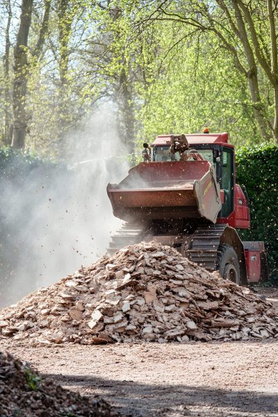 red-tractor-is-driving-through-pile-dirt