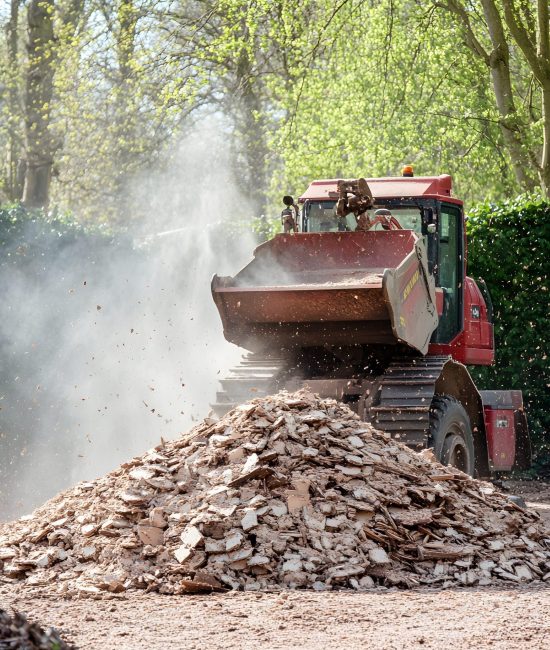 red-tractor-is-driving-through-pile-dirt